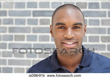 Portrait of young man in front of wall View Large Photo Image Stock Image - Portrait of young man in front of wall. Fotosearch