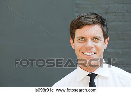 Portrait of young man in front of wall View Large Photo Image Stock Image - Portrait of young man in front of wall. Fotosearch
