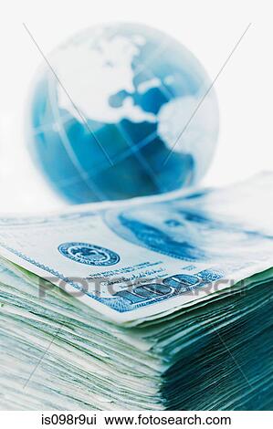 Stack of banknotes and globe View Large Photo Image Stock Image - Stack of banknotes and globe. Fotosearch