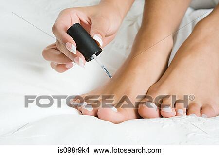 Woman painting toenails View Large Photo Image Picture - Woman painting toenails. Fotosearch