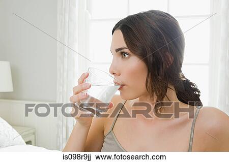 Young woman drinking water View Large Photo Image Stock Image - Young woman drinking water. Fotosearch