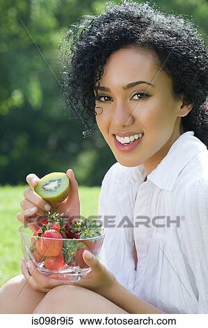 Young woman with bowl of fruit View Large Photo Image Stock Photography - Young woman with bowl of fruit. Fotosearch