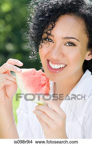 Young woman with slice of watermelon View Large Photo Image Picture - Young woman with slice of watermelon. Fotosearch