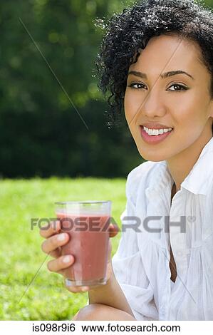 Young woman with smoothie View Large Photo Image Stock Photograph - Young woman with smoothie. Fotosearch