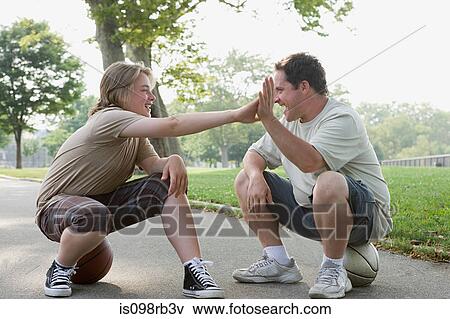 Father and son doing high five View Large Photo Image Stock Photo - Father and son doing high five. Fotosearch