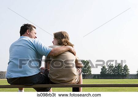 Father and son on a bench View Large Photo Image Stock Photograph - Father and son on a bench. Fotosearch