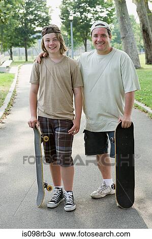 Father and son with skateboards View Large Photo Image Stock Photograph - Father and son with skateboards. Fotosearch