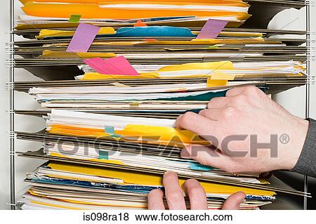Stock Photo - Person with files. Fotosearch