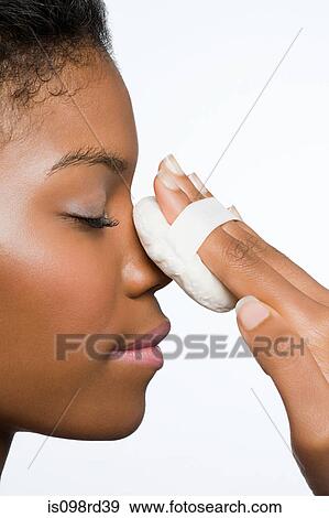 Woman applying face powder View Large Photo Image Stock Photo - Woman applying face powder. Fotosearch