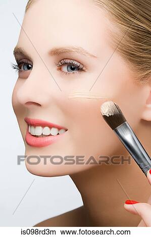 Woman applying foundation View Large Photo Image Picture - Woman applying foundation. Fotosearch