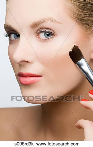 Stock Image - Woman applying foundation. Fotosearch