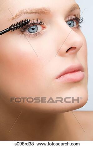 Woman applying mascara View Large Photo Image Stock Photo - Woman applying mascara. Fotosearch
