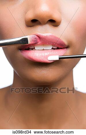 Woman having lipgloss applied View Large Photo Image Picture - Woman having lipgloss applied. Fotosearch