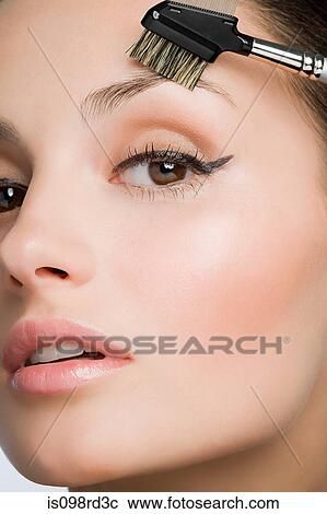 Woman with eyebrow brush View Large Photo Image Stock Image - Woman with eyebrow brush. Fotosearch