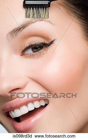 Stock Image - Woman with eyebrow brush. Fotosearch