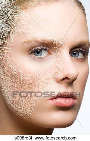 Stock Image - Woman with gauze on face. Fotosearch