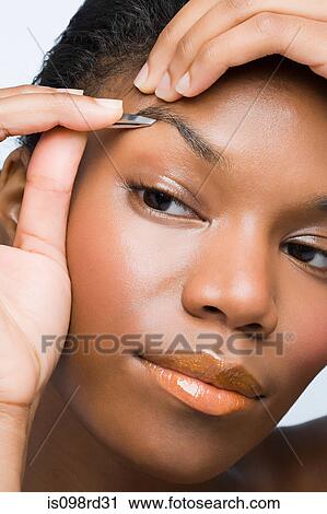 Young woman plucking eyebrows View Large Photo Image Stock Image - Young woman plucking eyebrows. Fotosearch