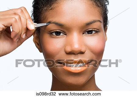 Young woman plucking eyebrows View Large Photo Image Stock Image - Young woman plucking eyebrows. Fotosearch