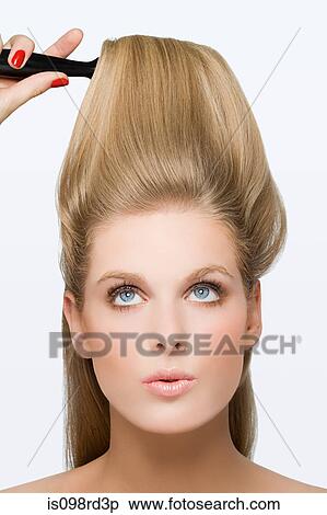 Stock Photography - Young woman using hairbrush. Fotosearch