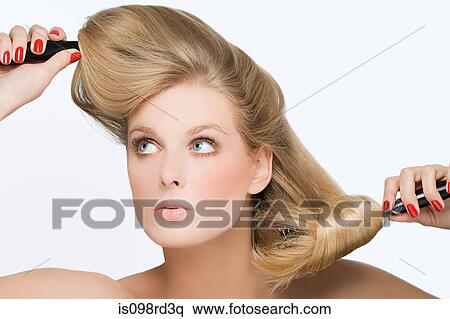 Young woman using hairbrushes View Large Photo Image Stock Photography - Young woman using hairbrushes. Fotosearch