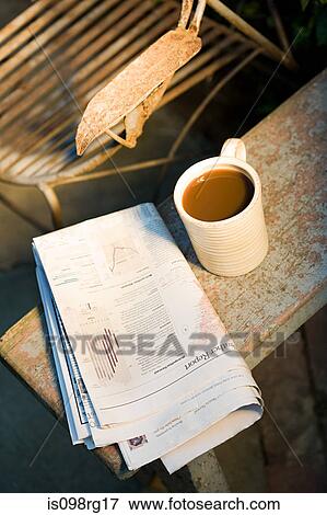 Coffee cup and newspaper outdoors View Large Photo Image Stock Photo - Coffee cup and newspaper outdoors. Fotosearch
