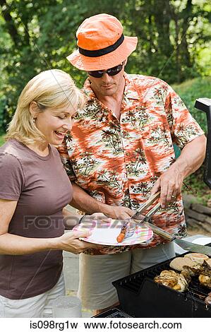 Stock Photo - Couple having a barbecue. Fotosearch