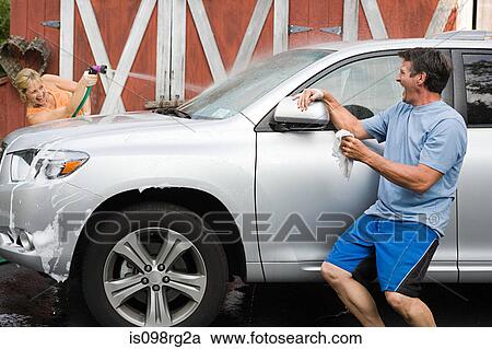 Couple having fun washing car View Large Photo Image Stock Image - Couple having fun washing car. Fotosearch
