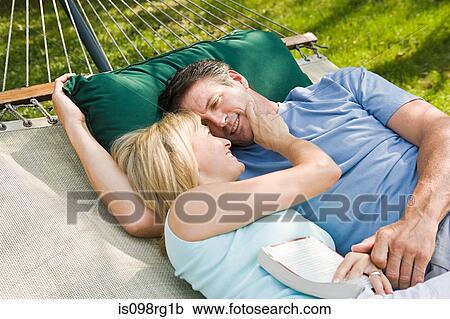 Stock Image - Couple lying in hammock. Fotosearch