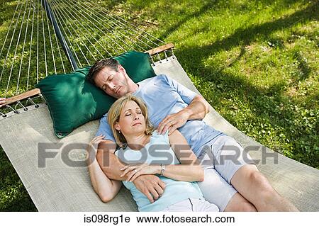 Couple lying in hammock View Large Photo Image Stock Image - Couple lying in hammock. Fotosearch