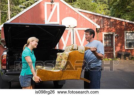 Couple moving armchair View Large Photo Image Stock Photograph - Couple moving armchair. Fotosearch
