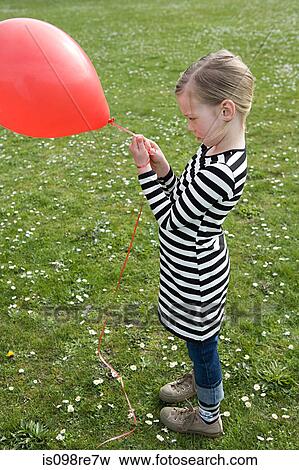 Stock Photo - Girl outdoors with balloon. Fotosearch