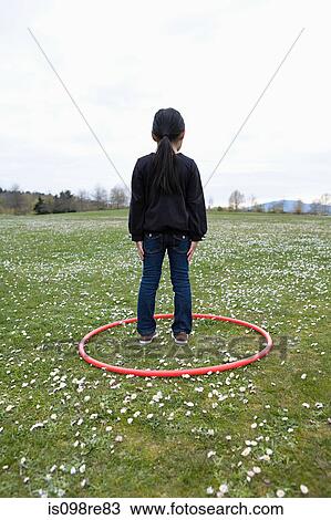 Girl standing in a hoop in a field View Large Photo Image Stock Image - Girl standing in a hoop in a field. Fotosearch