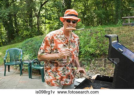 Man and barbecue View Large Photo Image Stock Photo - Man and barbecue. Fotosearch