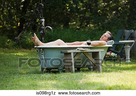 Man in outdoor bathtub View Large Photo Image Stock Photo - Man in outdoor bathtub. Fotosearch