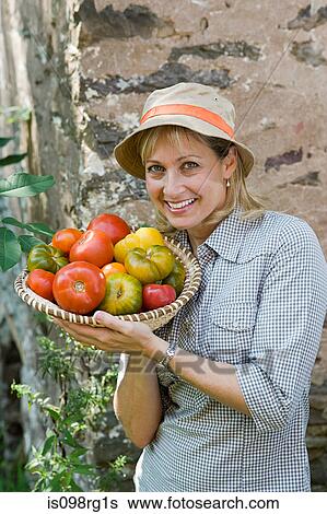 Woman with bowl of tomatoes View Large Photo Image Stock Photograph - Woman with bowl of tomatoes. Fotosearch