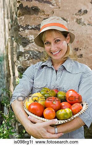 Woman with bowl of tomatoes View Large Photo Image Stock Photograph - Woman with bowl of tomatoes. Fotosearch