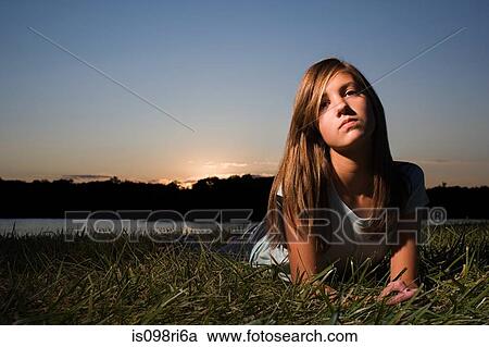 Girl lying on grass View Large Photo Image Stock Image - Girl lying on grass. Fotosearch