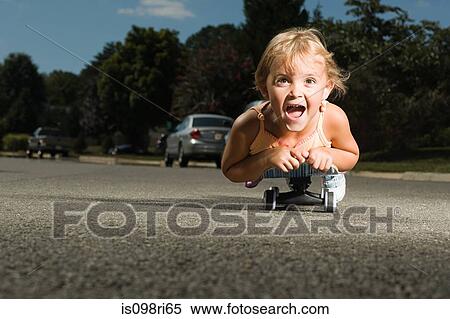 Little girl on a skateboard View Large Photo Image Stock Photography - Little girl on a skateboard. Fotosearch
