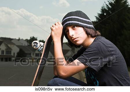 Teenage boy with a skateboard View Large Photo Image Stock Photo - Teenage boy with a skateboard. Fotosearch