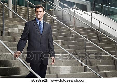 A businessman descending a staircase View Large Photo Image Stock Image - A businessman descending a staircase. Fotosearch