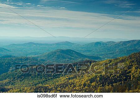 A view over tree covered mountains View Large Photo Image Stock Image - A view over tree covered mountains. Fotosearch