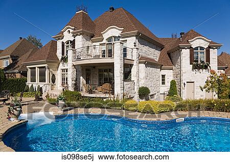 Stock Image - Large house with swimming pool. Fotosearch