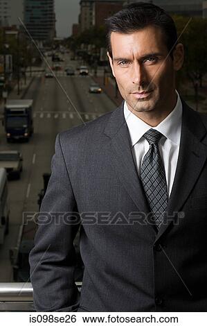 Portrait of a businessman against a city background View Large Photo Image Stock Photograph - Portrait of a businessman against a city background. Fotosearch