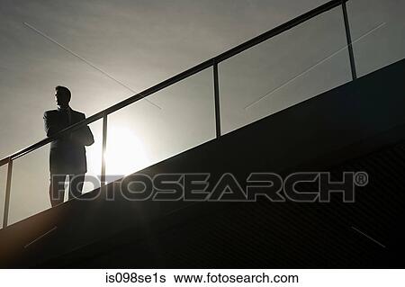 Silhouette of a businessman on a bridge View Large Photo Image Stock Photograph - Silhouette of a businessman on a bridge. Fotosearch