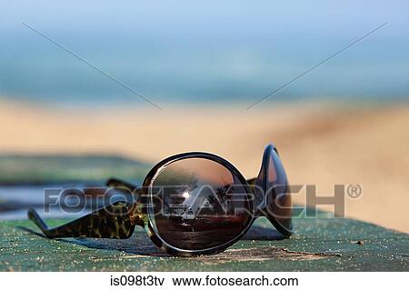 Sunglasses reflecting palm trees View Large Photo Image Stock Photo - Sunglasses reflecting palm trees. Fotosearch