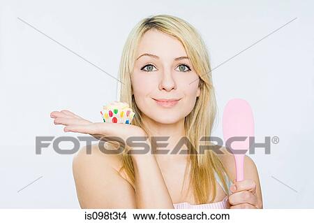 Young woman with cupcake and spoon View Large Photo Image Picture - Young woman with cupcake and spoon. Fotosearch