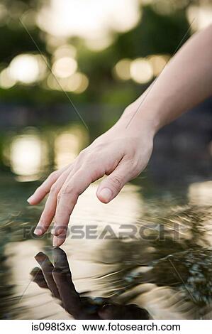 Stock Image - Female hand and water. Fotosearch