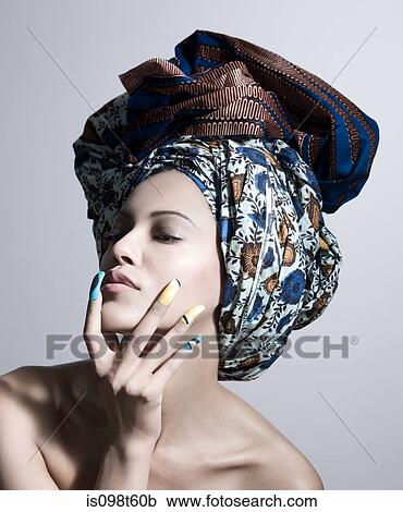 Young woman wearing head tie and artificial nails View Large Photo Image Stock Image - Young woman wearing head tie and artificial nails. Fotosearch