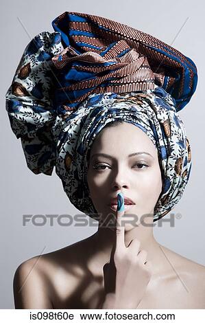 Young woman wearing head tie with finger on lips View Large Photo Image Stock Image - Young woman wearing head tie with finger on lips. Fotosearch