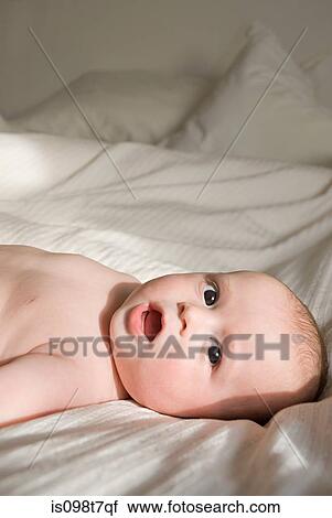 Baby boy on bed View Large Photo Image Stock Image - Baby boy on bed. Fotosearch